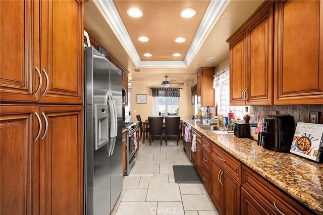9228 Whiting Way, Riverside, CA 92508 - kitchen with stainless steel appliances, a tray ceiling, crown molding, brown cabinetry, and recessed lighting