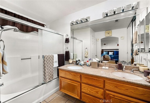 9228 Whiting Way, Riverside, CA 92508 - ensuite bathroom featuring tile patterned floors, double vanity, and bath / shower combo with glass door