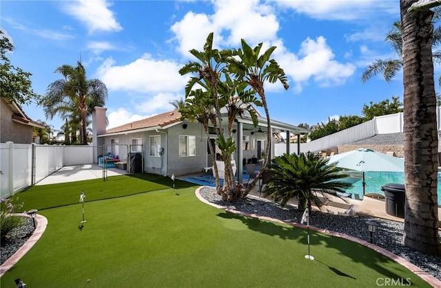 9228 Whiting Way, Riverside, CA 92508 - fenced backyard featuring a putting area and a patio