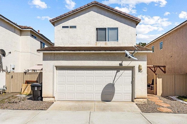 1527 Gold Run Rd, Chula Vista, CA 91913 - back of property with an attached garage, stucco siding, and driveway