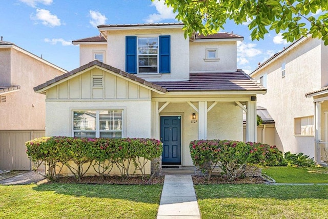 1527 Gold Run Rd, Chula Vista, CA 91913 - traditional-style home featuring a front yard, board and batten siding, stucco siding, and a tile roof