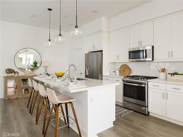 1673 Lexington Ln, San Pedro, CA 90732 - kitchen with stainless steel appliances, wood finished floors, backsplash, and light countertops