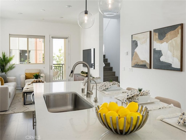 1673 Lexington Ln, San Pedro, CA 90732 - kitchen with open floor plan, light countertops, hanging light fixtures, and wood finished floors