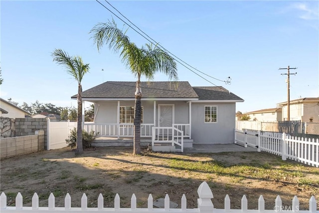 17055 San Bernardino Ave, Fontana, CA 92335 - view of front facade with stucco siding, a porch, and a fenced front yard