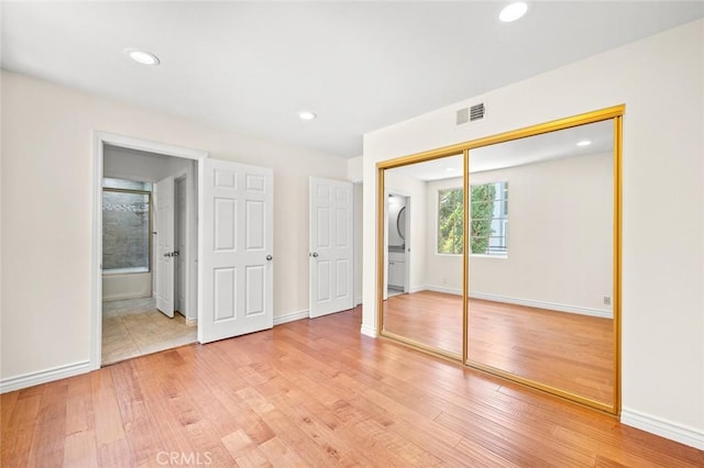 21557 Ambushers St, Diamond Bar, CA 91765 - unfurnished bedroom featuring stacked washing machine and dryer, light wood-style floors, a closet, recessed lighting, and ensuite bath