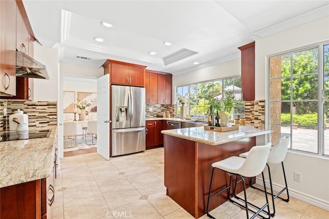 21557 Ambushers St, Diamond Bar, CA 91765 - kitchen with appliances with stainless steel finishes, ornamental molding, under cabinet range hood, a peninsula, and backsplash