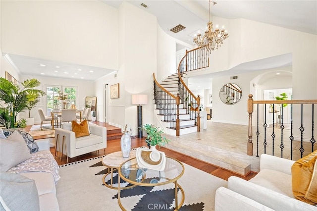 21557 Ambushers St, Diamond Bar, CA 91765 - living room featuring a chandelier, high vaulted ceiling, stairs, and wood finished floors