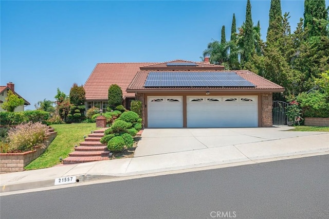 21557 Ambushers St, Diamond Bar, CA 91765 - view of front of property featuring a tile roof, a garage, solar panels, and concrete driveway