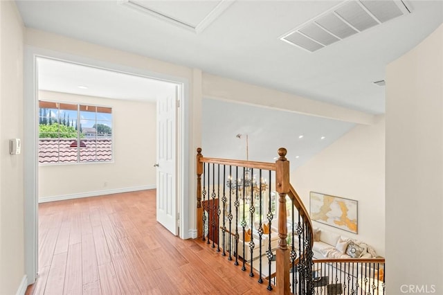 21557 Ambushers St, Diamond Bar, CA 91765 - hallway featuring wood finished floors, an upstairs landing, and attic access