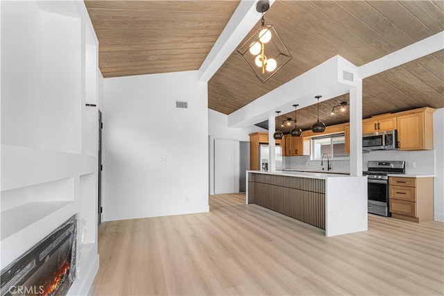 12302 Beaty Ave, Norwalk, CA 90650 - kitchen with appliances with stainless steel finishes, wood ceiling, light countertops, light wood finished floors, and a warm lit fireplace
