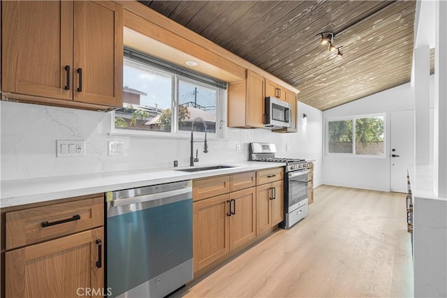 12302 Beaty Ave, Norwalk, CA 90650 - kitchen with appliances with stainless steel finishes, light wood-style flooring, decorative backsplash, vaulted ceiling, and light countertops