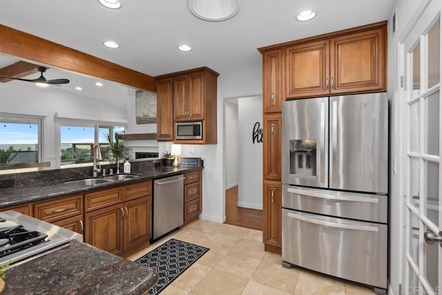 4704 Jumano Ave, San Diego, CA 92117 - kitchen with stainless steel appliances, brown cabinets, ceiling fan, recessed lighting, and vaulted ceiling