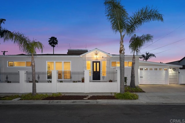 4704 Jumano Ave, San Diego, CA 92117 - view of front of house featuring driveway, an attached garage, and stucco siding