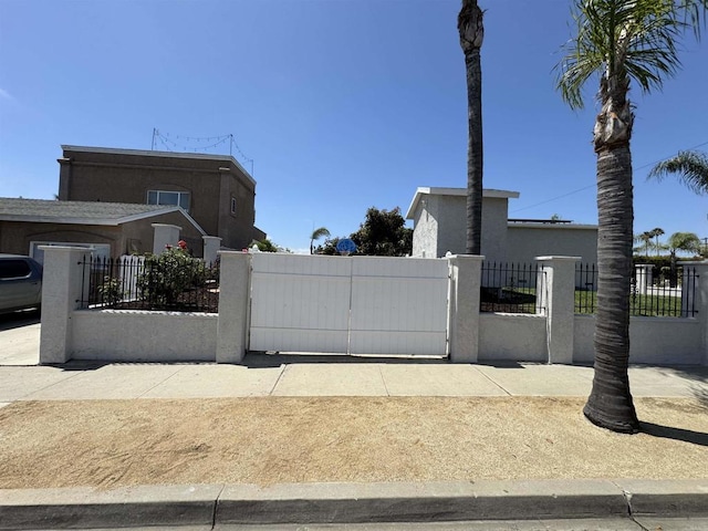4704 Jumano Ave, San Diego, CA 92117 - view of side of home featuring a fenced front yard, stucco siding, and a gate