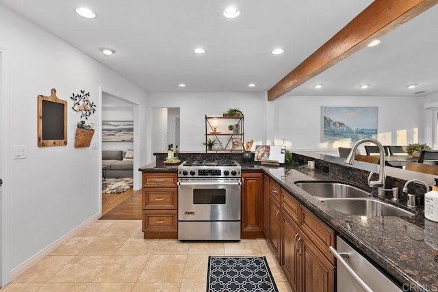 4704 Jumano Ave, San Diego, CA 92117 - kitchen featuring appliances with stainless steel finishes, brown cabinets, dark stone counters, light tile patterned floors, and recessed lighting