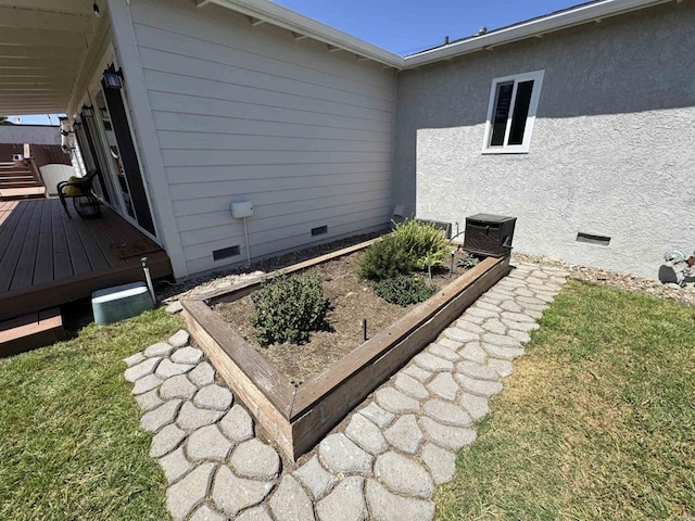 4704 Jumano Ave, San Diego, CA 92117 - view of side of home with crawl space, a deck, and a vegetable garden