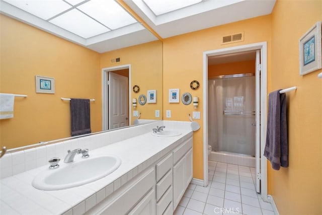 50 Los Cabos, Dana Point, CA 92629 - bathroom featuring tile patterned floors, double vanity, a shower, and a skylight
