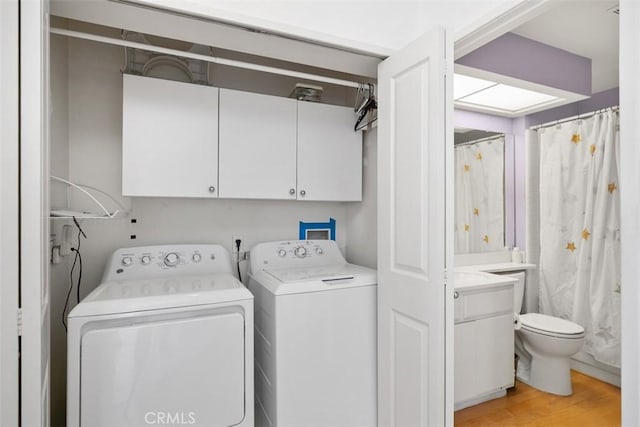 50 Los Cabos, Dana Point, CA 92629 - laundry room featuring cabinet space, washer and dryer, and light wood-style flooring