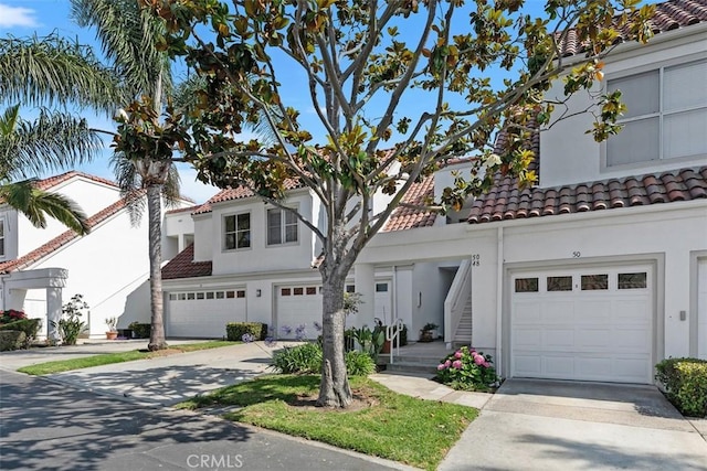 50 Los Cabos, Dana Point, CA 92629 - mediterranean / spanish home featuring driveway, a tiled roof, an attached garage, and stucco siding