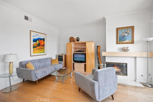 50 Los Cabos, Dana Point, CA 92629 - living room with ornamental molding, light wood-style flooring, and a glass covered fireplace
