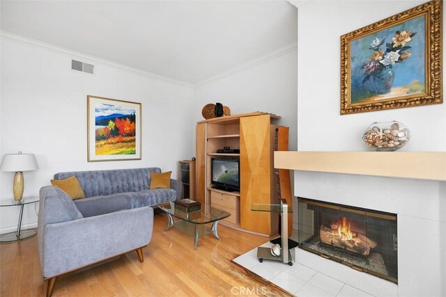 50 Los Cabos, Dana Point, CA 92629 - living room with ornamental molding, light wood-style floors, and a fireplace with flush hearth