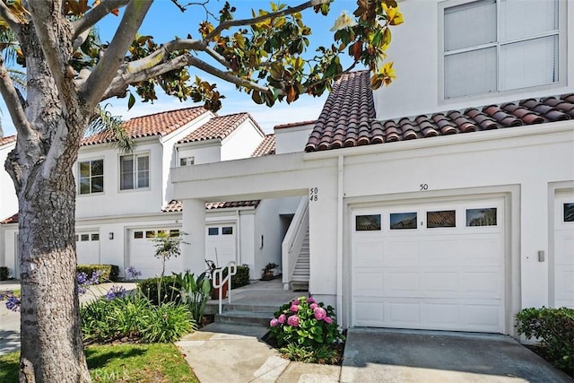 50 Los Cabos, Dana Point, CA 92629 - mediterranean / spanish-style home featuring a tile roof, stucco siding, concrete driveway, stairs, and an attached garage