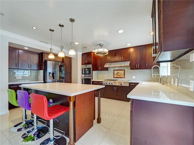 2903 Parkview Dr, Alhambra, CA 91803 - kitchen featuring appliances with stainless steel finishes, a breakfast bar area, tasteful backsplash, under cabinet range hood, and a kitchen island