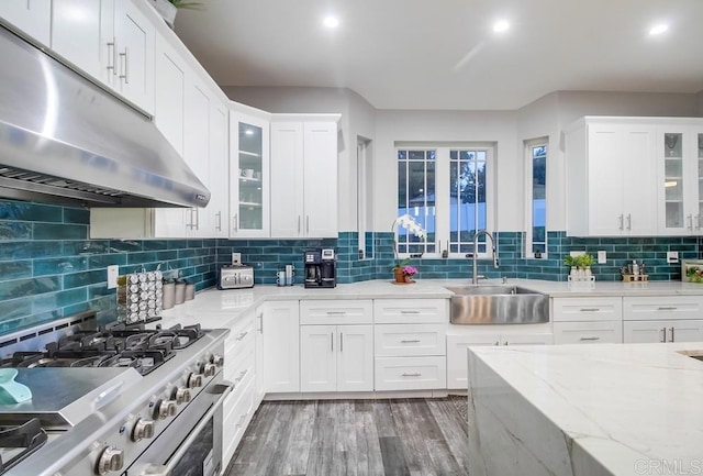 2184 Pacific Crest Dr, Alpine, CA 91901 - kitchen with under cabinet range hood, gas range, white cabinets, wood finished floors, and backsplash