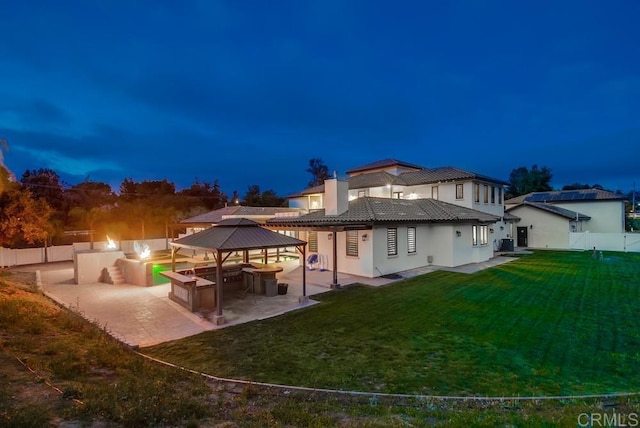 2184 Pacific Crest Dr, Alpine, CA 91901 - back of house at night featuring a gazebo, a patio area, stucco siding, and a tile roof