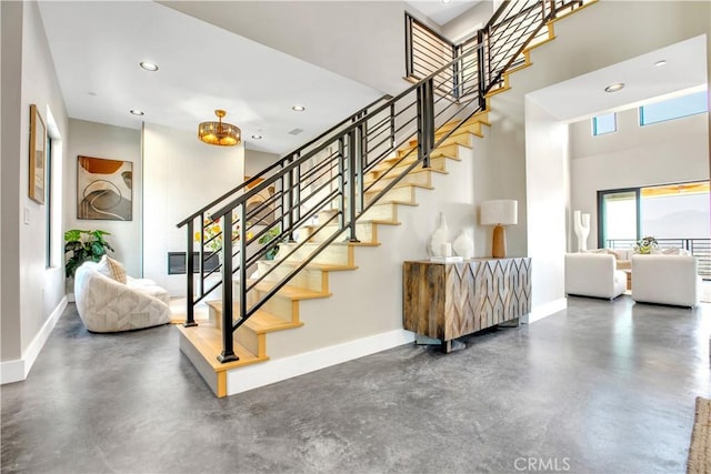 2380 Scenic Ridge Dr, Chino Hills, CA 91709 - staircase featuring concrete flooring, a towering ceiling, and recessed lighting