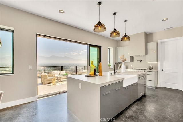 2380 Scenic Ridge Dr, Chino Hills, CA 91709 - kitchen featuring finished concrete flooring, hanging light fixtures, light countertops, modern cabinets, and a center island with sink