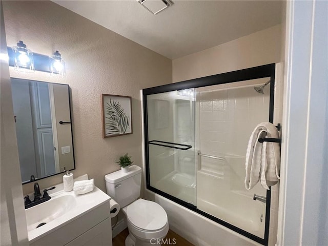28652 Bridge Water Ln, Menifee, CA 92584 - bathroom with a textured wall, vanity, and enclosed tub / shower combo