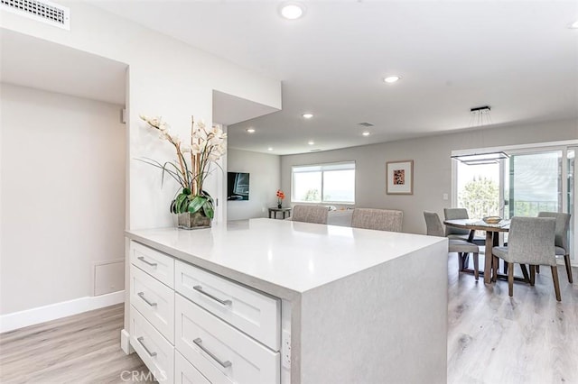 4014 Calle Sonora Oeste Unit 2B, Laguna Woods, CA 92637 - kitchen with white cabinets, light wood-style flooring, recessed lighting, and light countertops