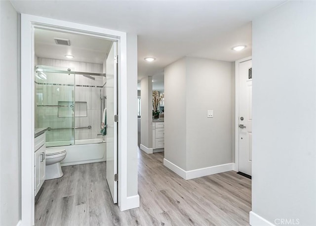 4014 Calle Sonora Oeste Unit 2B, Laguna Woods, CA 92637 - full bathroom with wood finished floors, shower / bath combination with glass door, vanity, and recessed lighting