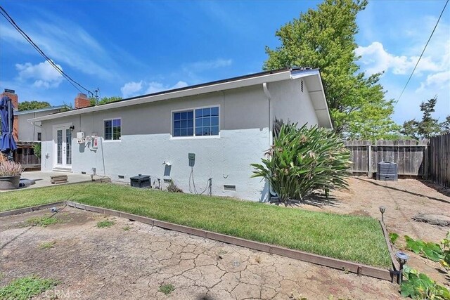 367 E Pacific Ave, Fairfield, CA 94533 - view of property exterior with french doors, crawl space, a chimney, and stucco siding