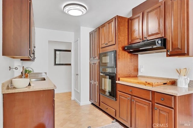 367 E Pacific Ave, Fairfield, CA 94533 - kitchen with black appliances, under cabinet range hood, light countertops, and brown cabinets