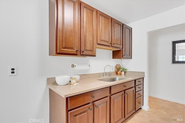 367 E Pacific Ave, Fairfield, CA 94533 - kitchen with light stone counters, brown cabinets, and light tile patterned floors