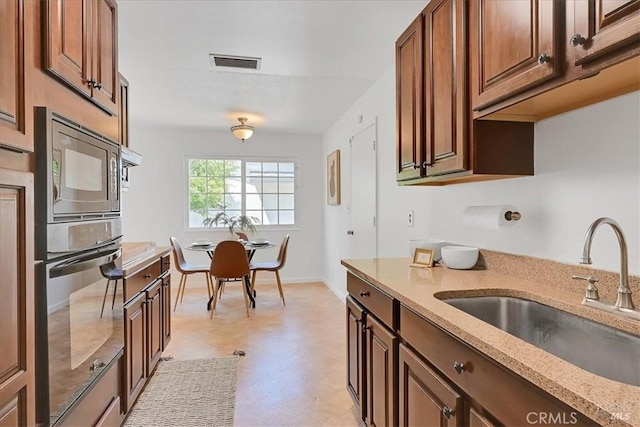 367 E Pacific Ave, Fairfield, CA 94533 - kitchen with oven, built in microwave, light stone counters, and light floors