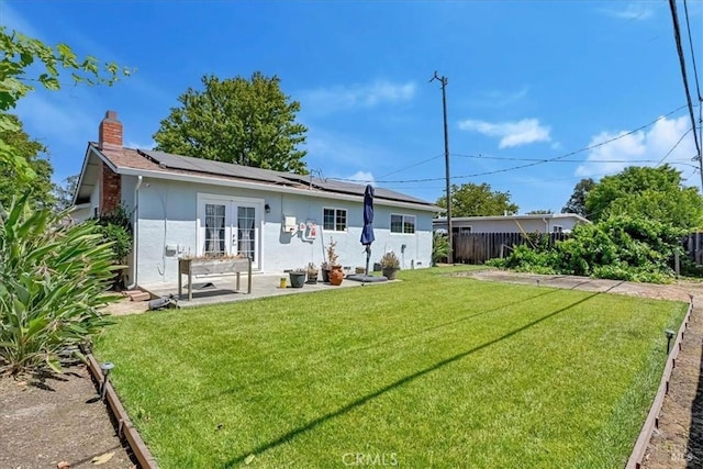 367 E Pacific Ave, Fairfield, CA 94533 - back of house featuring french doors, solar panels, a chimney, a patio, and stucco siding