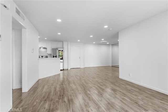 3961 Via Marisol Unit 218, Los Angeles, CA 90042 - unfurnished living room featuring recessed lighting and light wood finished floors