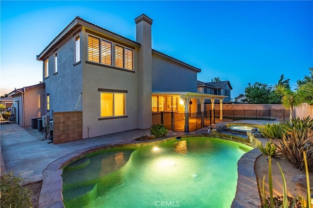 40028 Bluff Ct, Palmdale, CA 93551 - back of property with a patio, a chimney, a fenced backyard, and stucco siding
