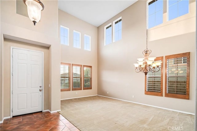 40028 Bluff Ct, Palmdale, CA 93551 - foyer entrance featuring a chandelier, a high ceiling, carpet, and tile patterned floors
