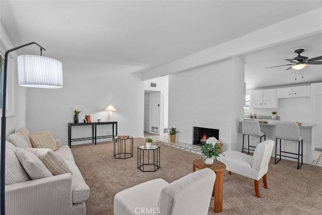 2323 Colgate Dr, Costa Mesa, CA 92626 - living room featuring light colored carpet, a fireplace, and a ceiling fan