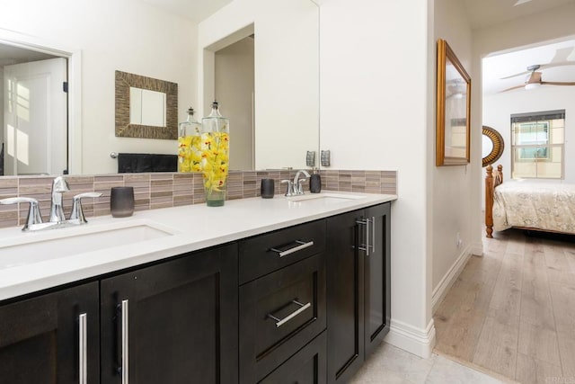 4336 Harbor Way Unit 1, Oceanside, CA 92056 - bathroom with decorative backsplash, double vanity, ceiling fan, ensuite bath, and wood finished floors
