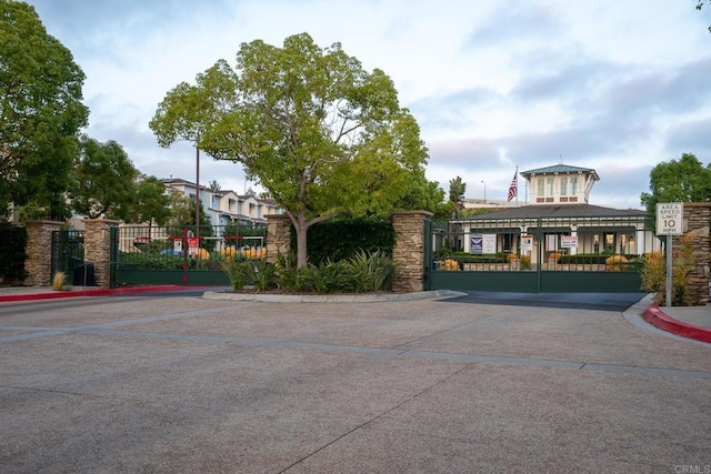 4336 Harbor Way Unit 1, Oceanside, CA 92056 - view of concrete road featuring a gate, curbs, a gated entry, and traffic signs