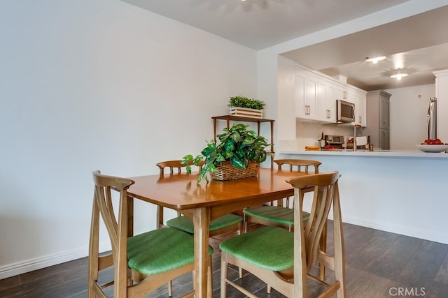 240 Nice Ln Unit 114, Newport Beach, CA 92663 - dining area with dark wood-style floors and baseboards