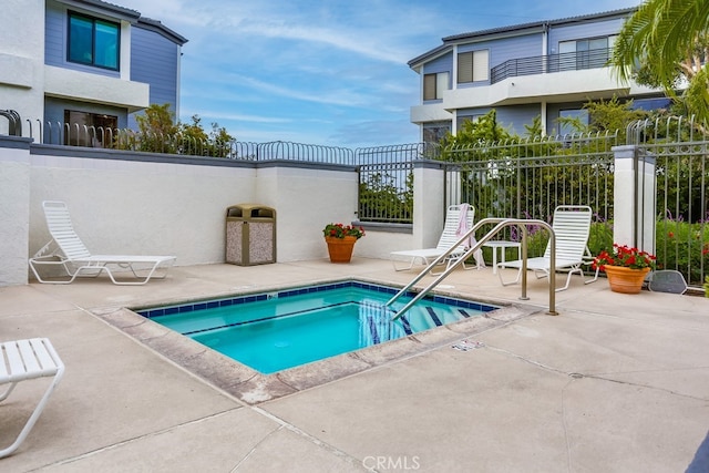 240 Nice Ln Unit 114, Newport Beach, CA 92663 - view of swimming pool featuring a patio area