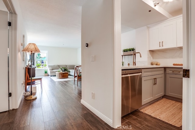 240 Nice Ln Unit 114, Newport Beach, CA 92663 - kitchen with dishwasher, dark wood-style flooring, open floor plan, gray cabinetry, and light countertops