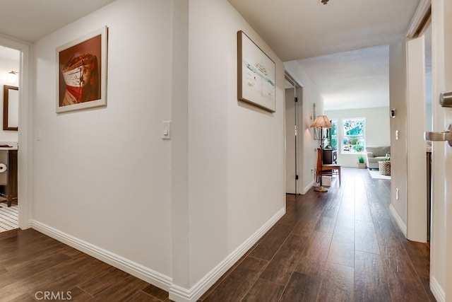 240 Nice Ln Unit 114, Newport Beach, CA 92663 - corridor featuring dark wood-style floors and baseboards