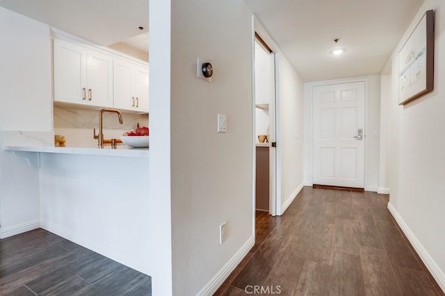 240 Nice Ln Unit 114, Newport Beach, CA 92663 - hallway with dark wood-style flooring and a sink